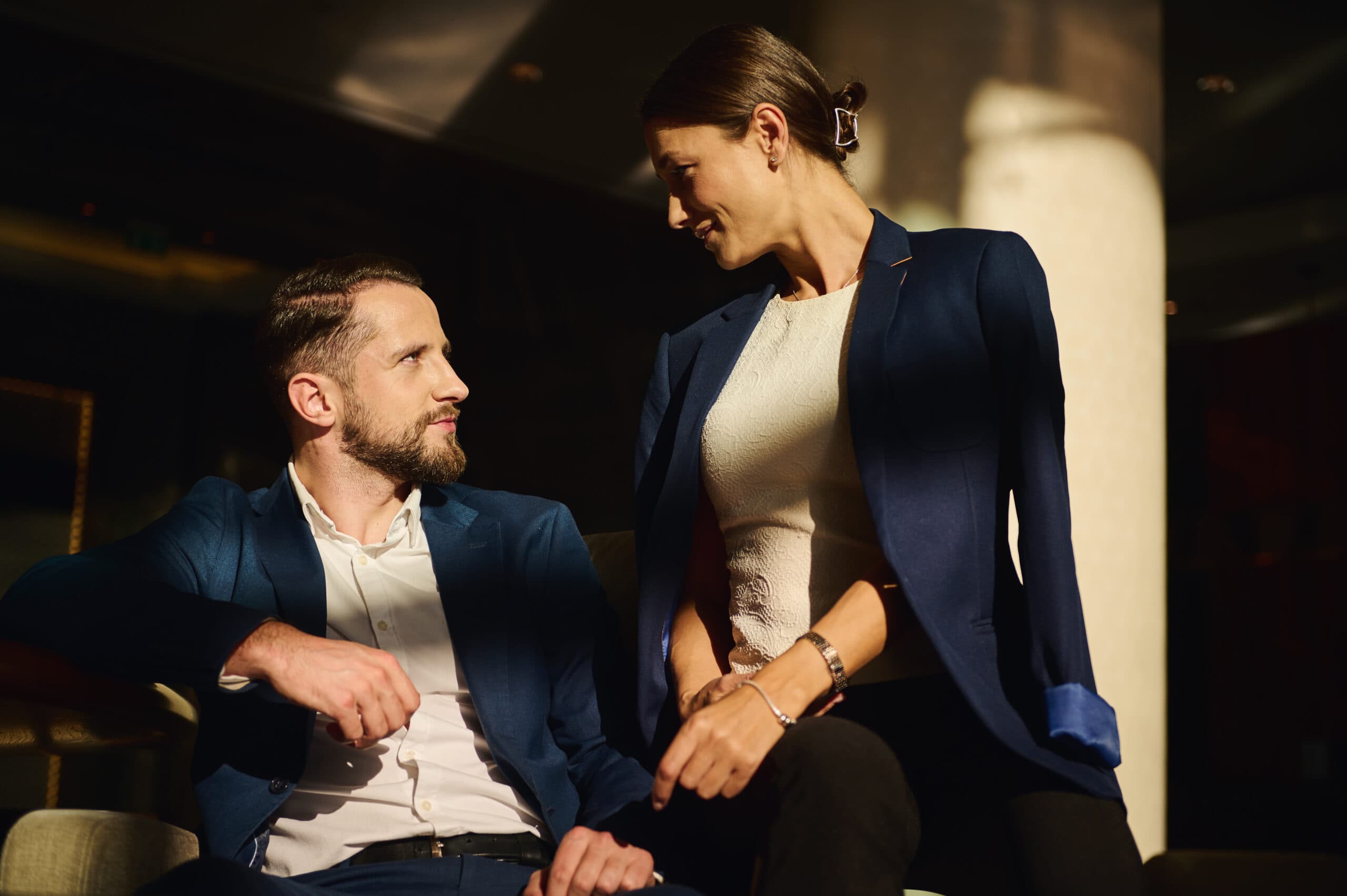 Beautiful couple talking together in a luxury hotel lounge